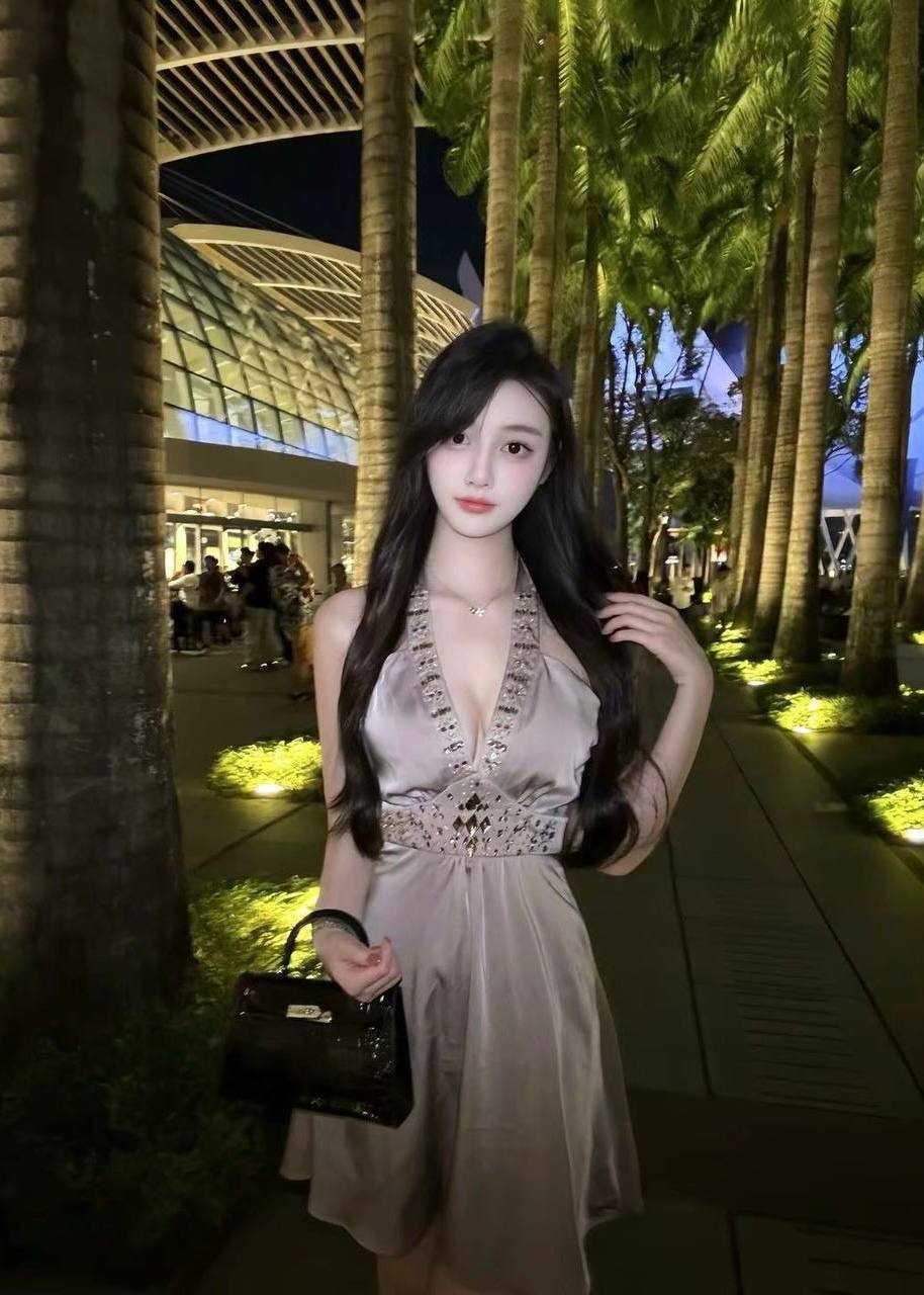 Xiaoling – Elegant Chinese model walking gracefully in Kuala Lumpur night scene.