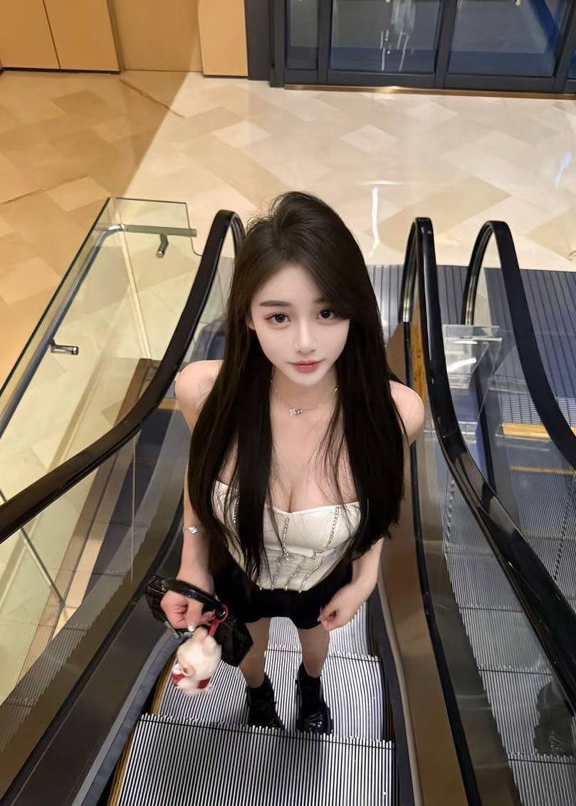 Xiaoling – Beautiful Chinese model on an escalator in Kuala Lumpur shopping mall.